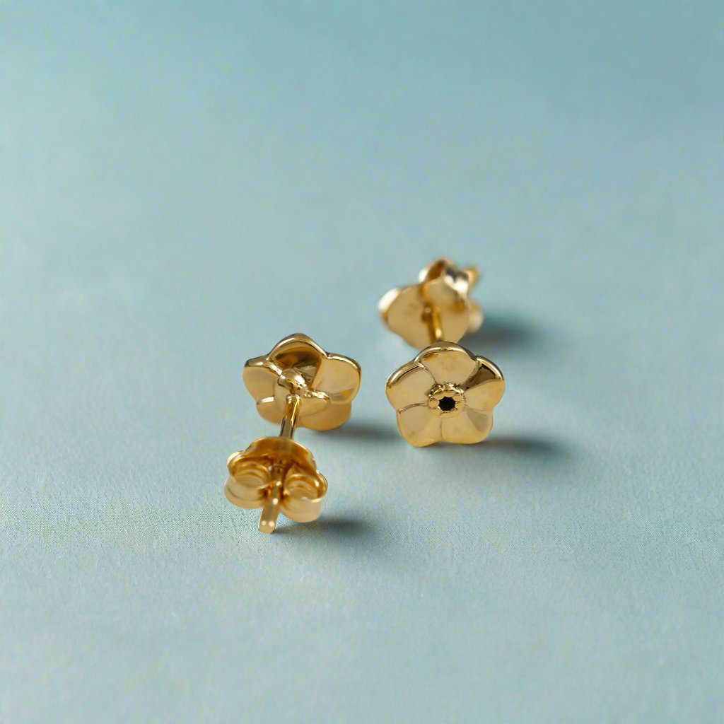 Tiny gold vermeil stud earrings with a delicate forget-me-not design by Scarlett Jewellery.